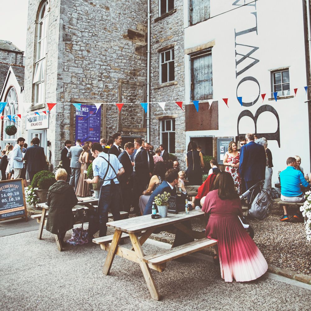 Guests Gather for Wedding at Holmes Mill in Clitheroe | Lace Bridal Cape Veil &amp; Fishtail Wedding Dress by Pronovias | On Love and Photography