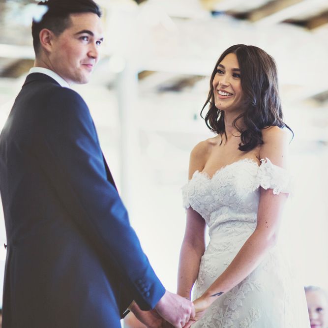 Wedding Ceremony | Bride in Embroidered Pronovias Wedding Dress with Off Shoulder Sleeves and Veil Cape | Groom in Navy Tails and Grey Waistcoat | Bride Wearing Hair Down | Lace Bridal Cape Veil &amp; Fishtail Wedding Dress by Pronovias | On Love and Photography