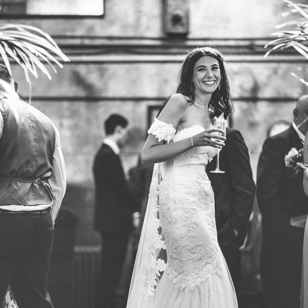 Bride in Fishtail Pronovias Wedding Dress with Off Shoulder Sleeves and Veil Cape | Bride Wearing Hair Down | Lace Bridal Cape Veil &amp; Fishtail Wedding Dress by Pronovias | On Love and Photography