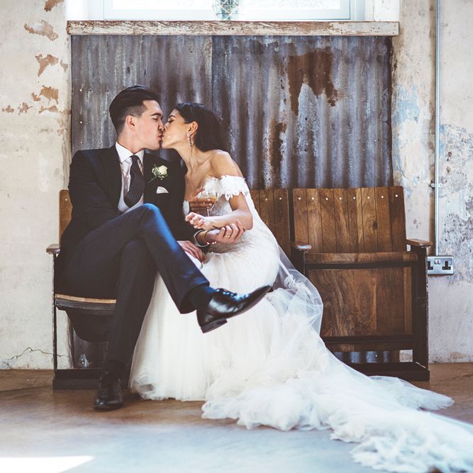 Bride in Fishtail Pronovias Wedding Dress with Off Shoulder Sleeves and Veil Cape | Groom in Navy Tails and Grey Waistcoat | Bride Wearing Hair Down | Lace Bridal Cape Veil &amp; Fishtail Wedding Dress by Pronovias | On Love and Photography