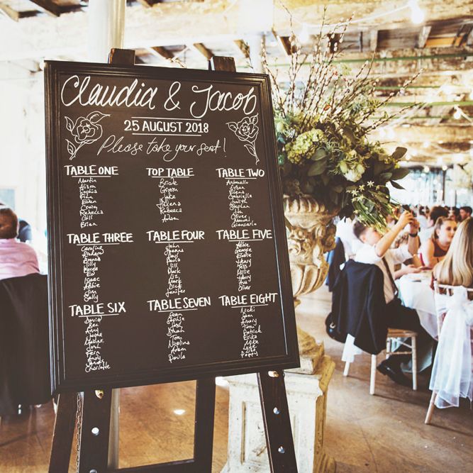 Chalkboard Wedding Seating Plan | Oversized Floral Urn | Lace Bridal Cape Veil &amp; Fishtail Wedding Dress by Pronovias | On Love and Photography