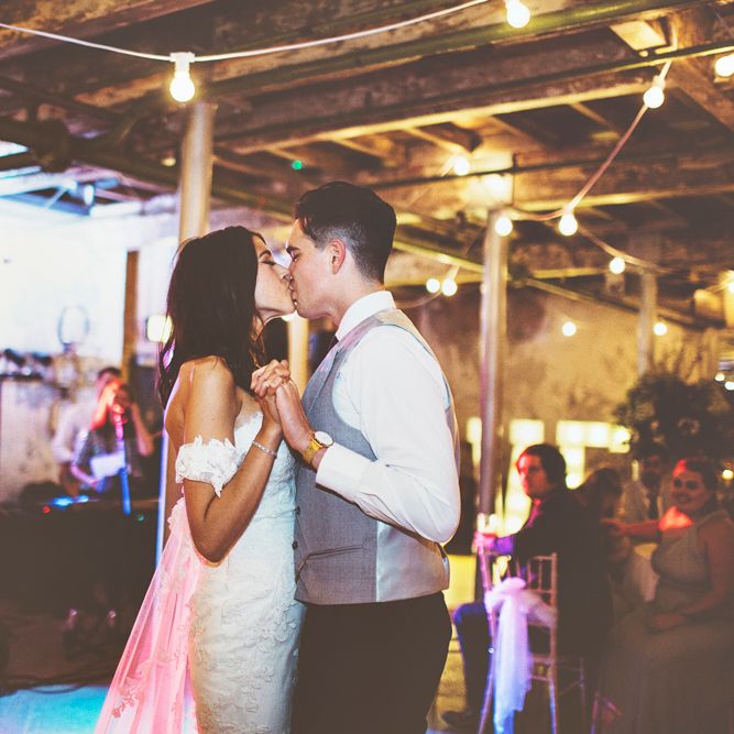 First Dance | Bride in Fishtail Pronovias Wedding Dress with Off Shoulder Sleeves and Veil Cape | Groom in Navy Tails and Grey Waistcoat | Bride Wearing Hair Down | Festoon Lights | Lace Bridal Cape Veil &amp; Fishtail Wedding Dress by Pronovias | On Love and Photography