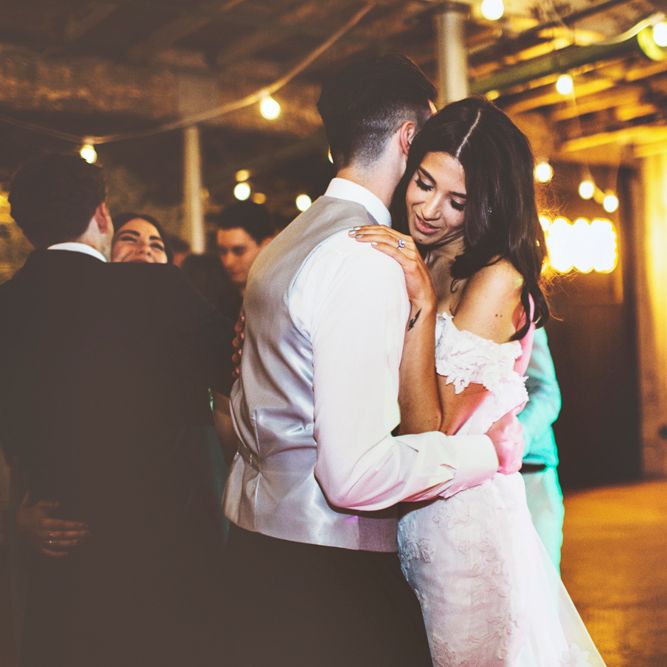First Dance | Bride in Fishtail Pronovias Wedding Dress with Off Shoulder Sleeves and Veil Cape | Groom in Navy Tails and Grey Waistcoat | Bride Wearing Hair Down | Festoon Lights | Lace Bridal Cape Veil &amp; Fishtail Wedding Dress by Pronovias | On Love and Photography