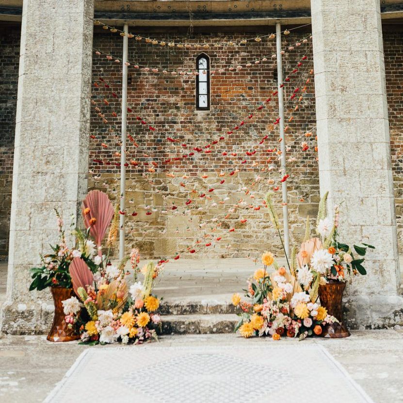 Altar decor at Chiddingstone Castle with string flower heads and floral arrangements