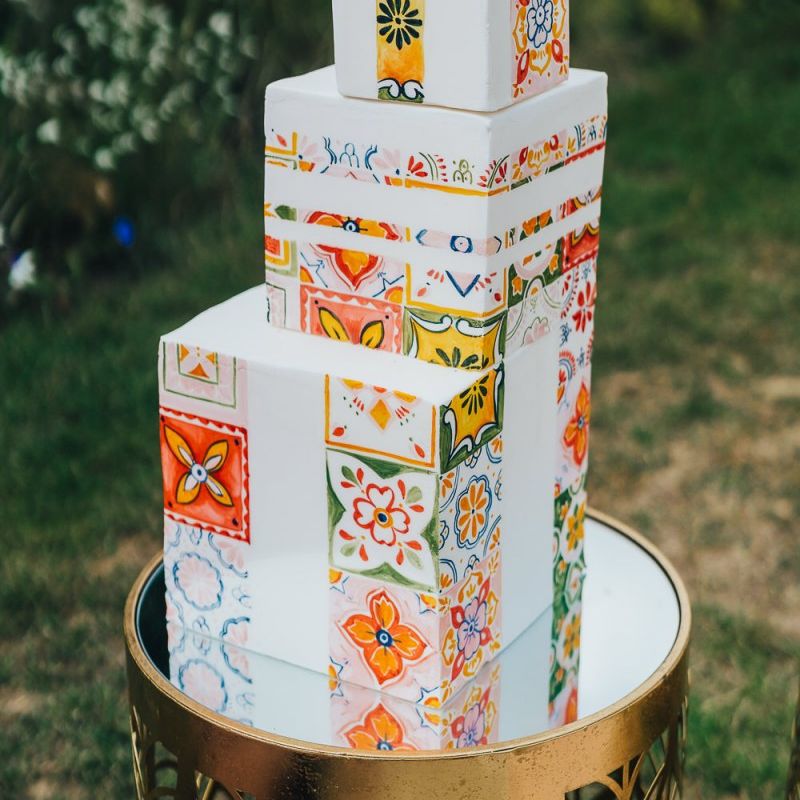 Square wedding cake with colourful tile motif at Chiddingstone Castle