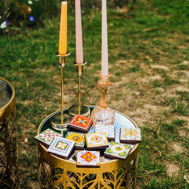 Gold candlesticks, coloured candles and tiles decor