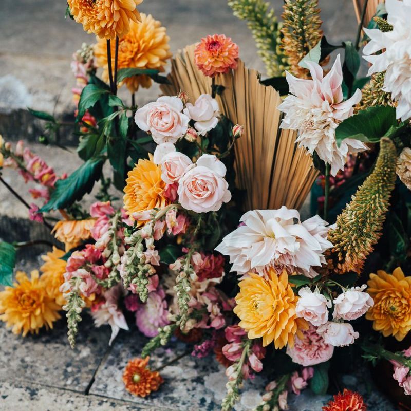 Tropical flower arrangements with roses and dahlias at Chiddingstone Castle