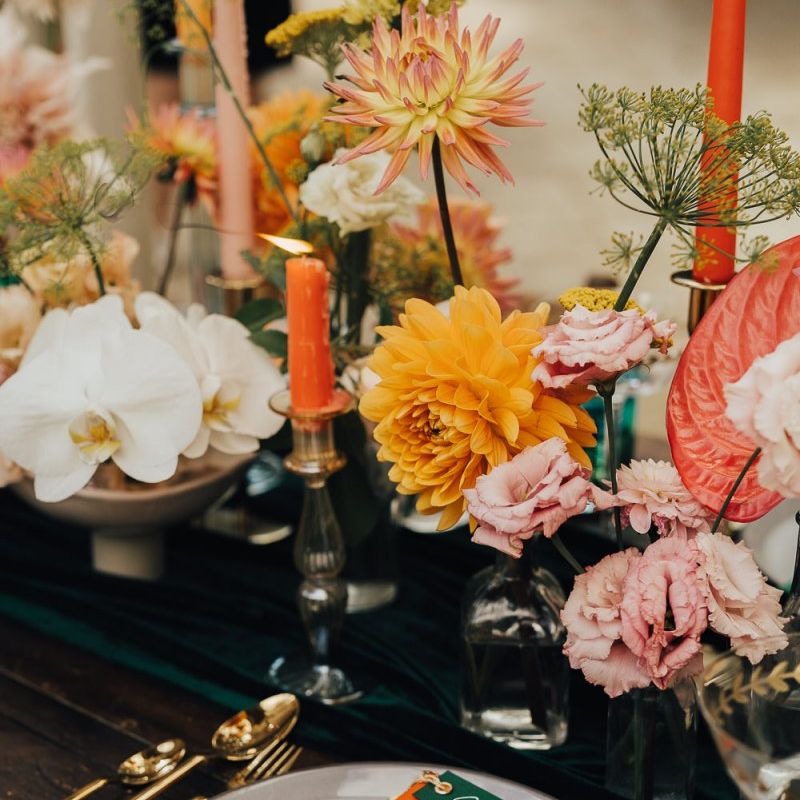 Place setting with gold cutlery and colourful menu card