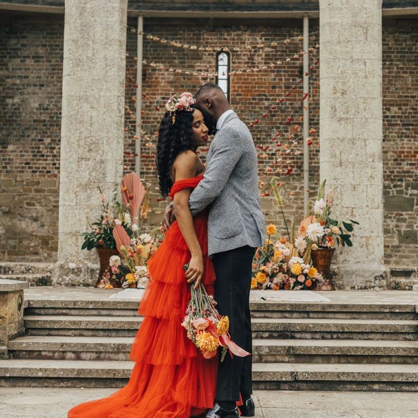 Stylish bride and groom embracing at Chiddingstone Castle