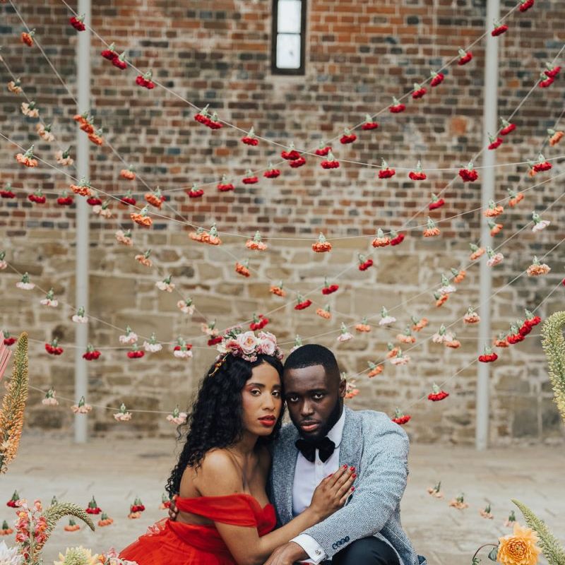 Intimate portrait in front of strung up flower heads at Chiddingstone Castle