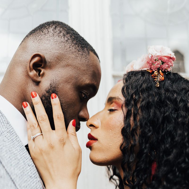 Intimate wedding portrait with bride wearing red nail polish