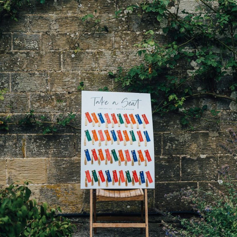 colourful Seating chart with name tags and tassels