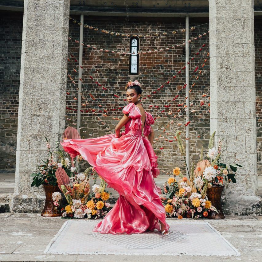 bride in bright pink Emma Beaumont wedding dress at Chiddingstone Castle