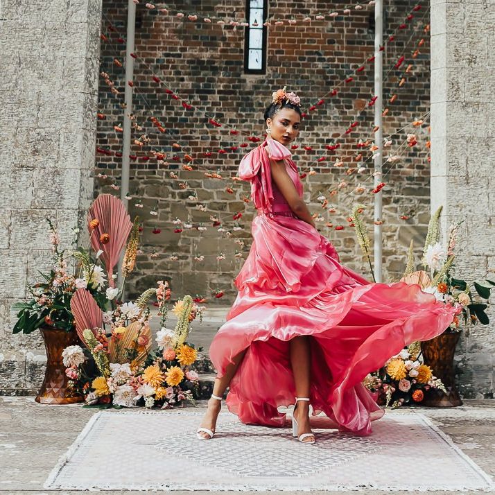 stylish bride in pink satin wedding dress by Emma Beaumont