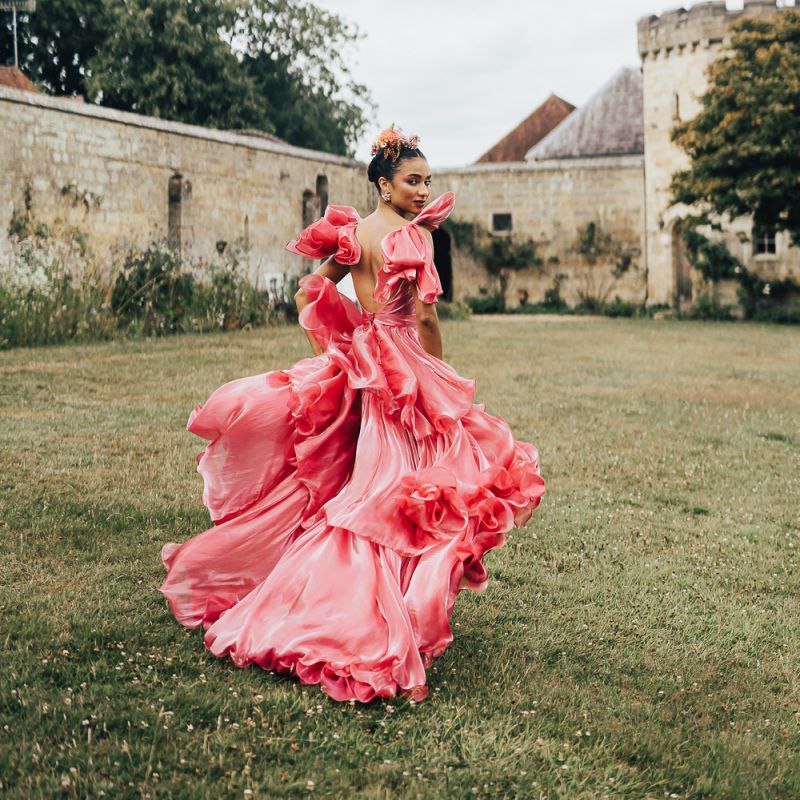 black bride in pink wedding dress at Chiddingstone Castle