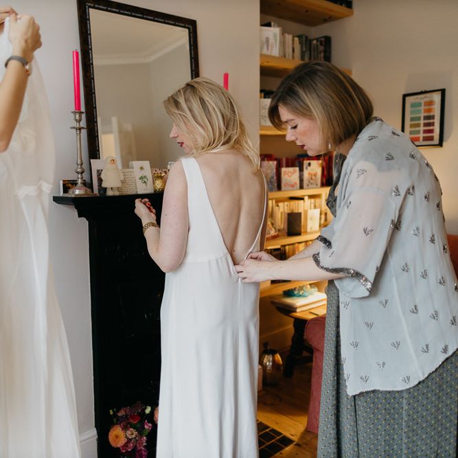 Bride getting ready in a Cathleen Jia dress for a colourful kitsch celebration in London
