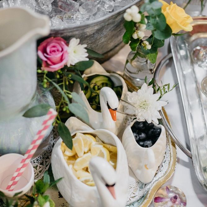 Ceramic animal pots and fun styling  for kitsch reception with pine cone wedding decor