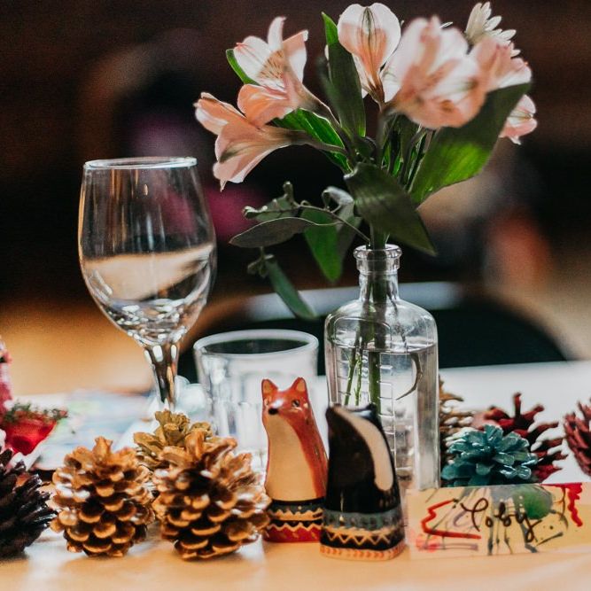 Centrepieces with pine cone wedding decor bright floral arrangements and ceramic animals