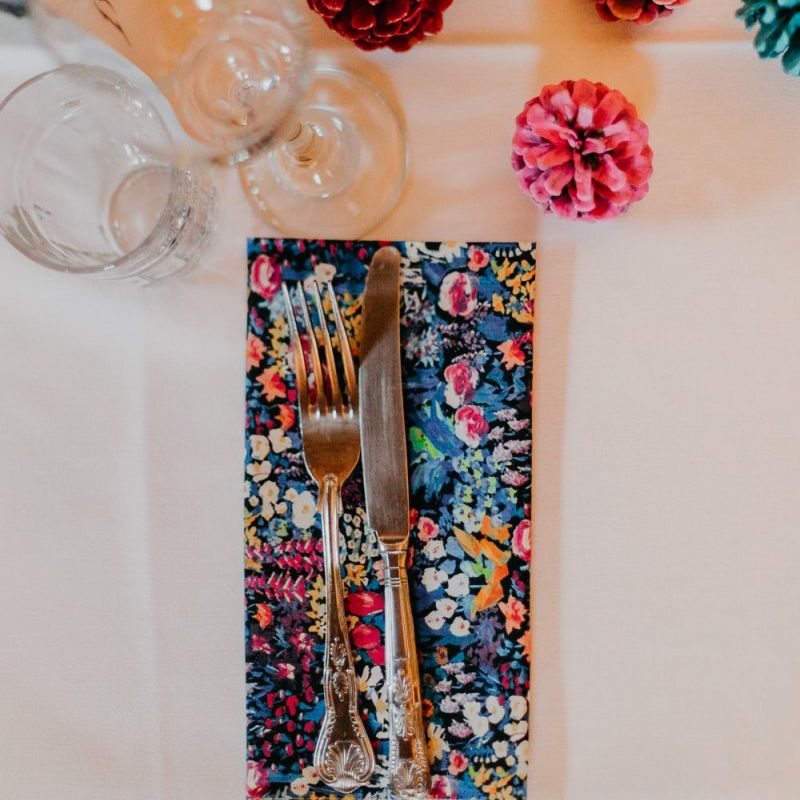 Spray painted pine cone wedding decor and handmade liberty print napkins