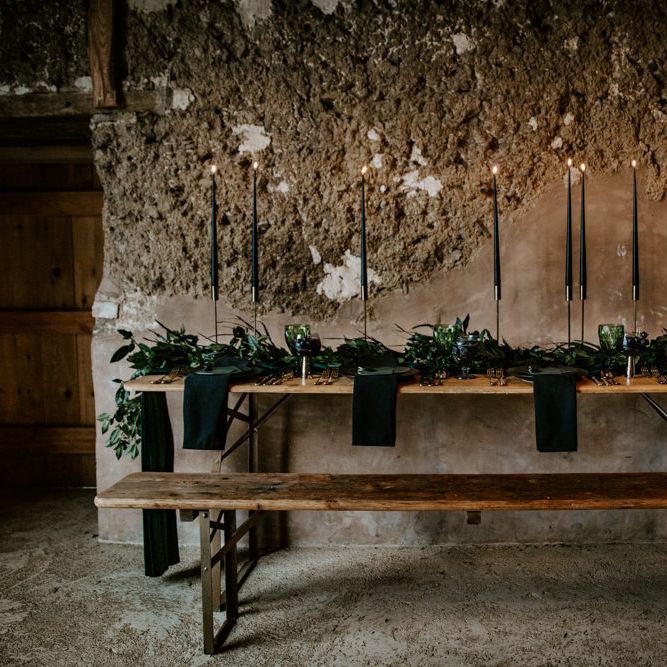 Black Taper Candles &amp; Greenery Garland Wedding Table Decor | Forest Green and Black Dark Decadence Wedding Inspiration in a Rustic Barn Planned &amp; Styled by Knots &amp; Kisses with Images by Daze of Glory Photography