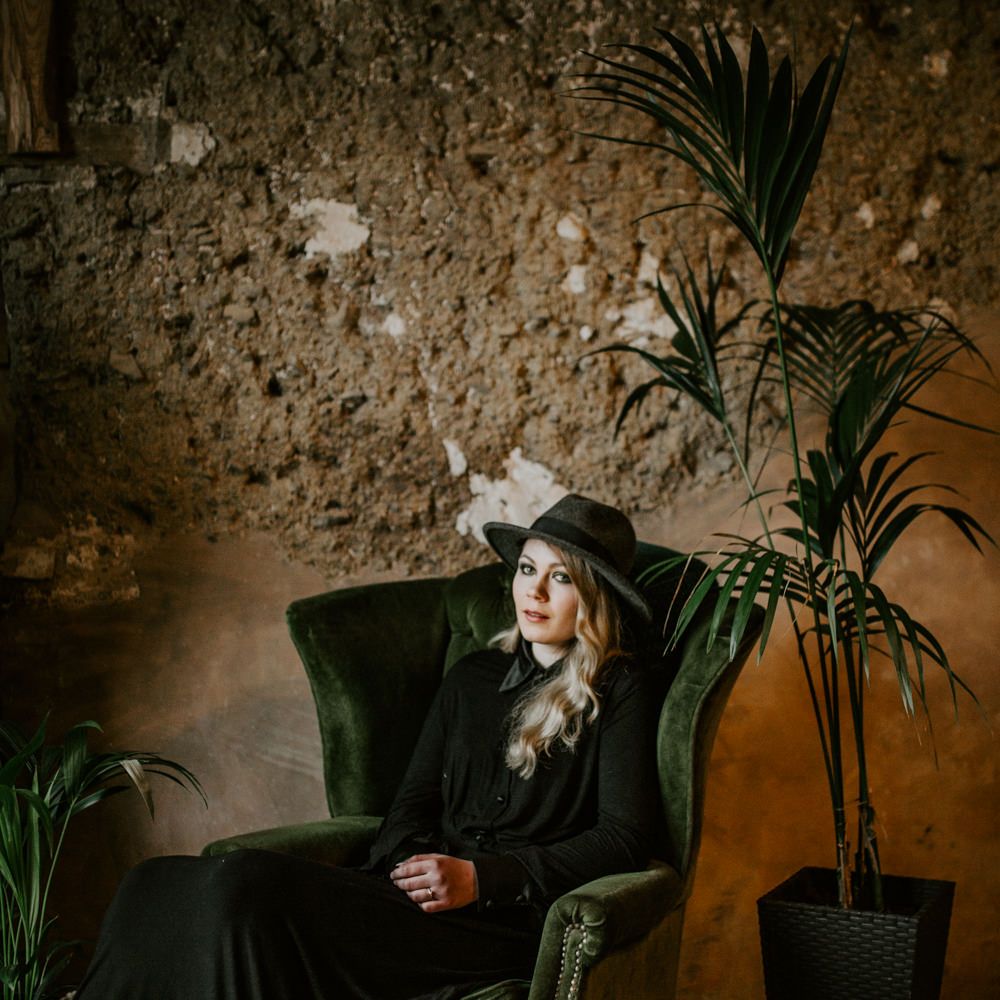 Bride in Black Wedding Dress &amp; Hat with Leather Jacket | Forest Green and Black Dark Decadence Wedding Inspiration in a Rustic Barn Planned &amp; Styled by Knots &amp; Kisses with Images by Daze of Glory Photography
