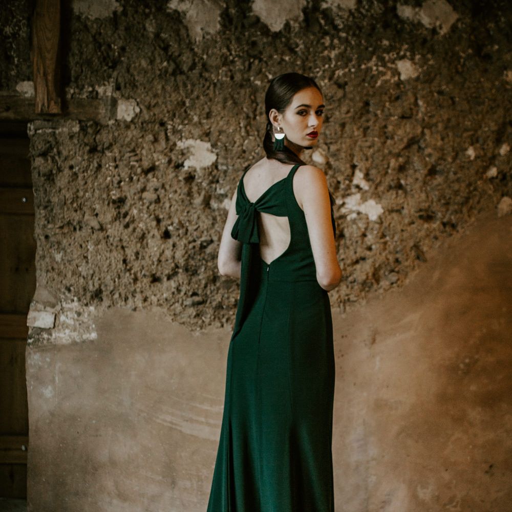 Bridesmaid in Tie Back Forest Green Dress | Forest Green and Black Dark Decadence Wedding Inspiration in a Rustic Barn Planned &amp; Styled by Knots &amp; Kisses with Images by Daze of Glory Photography