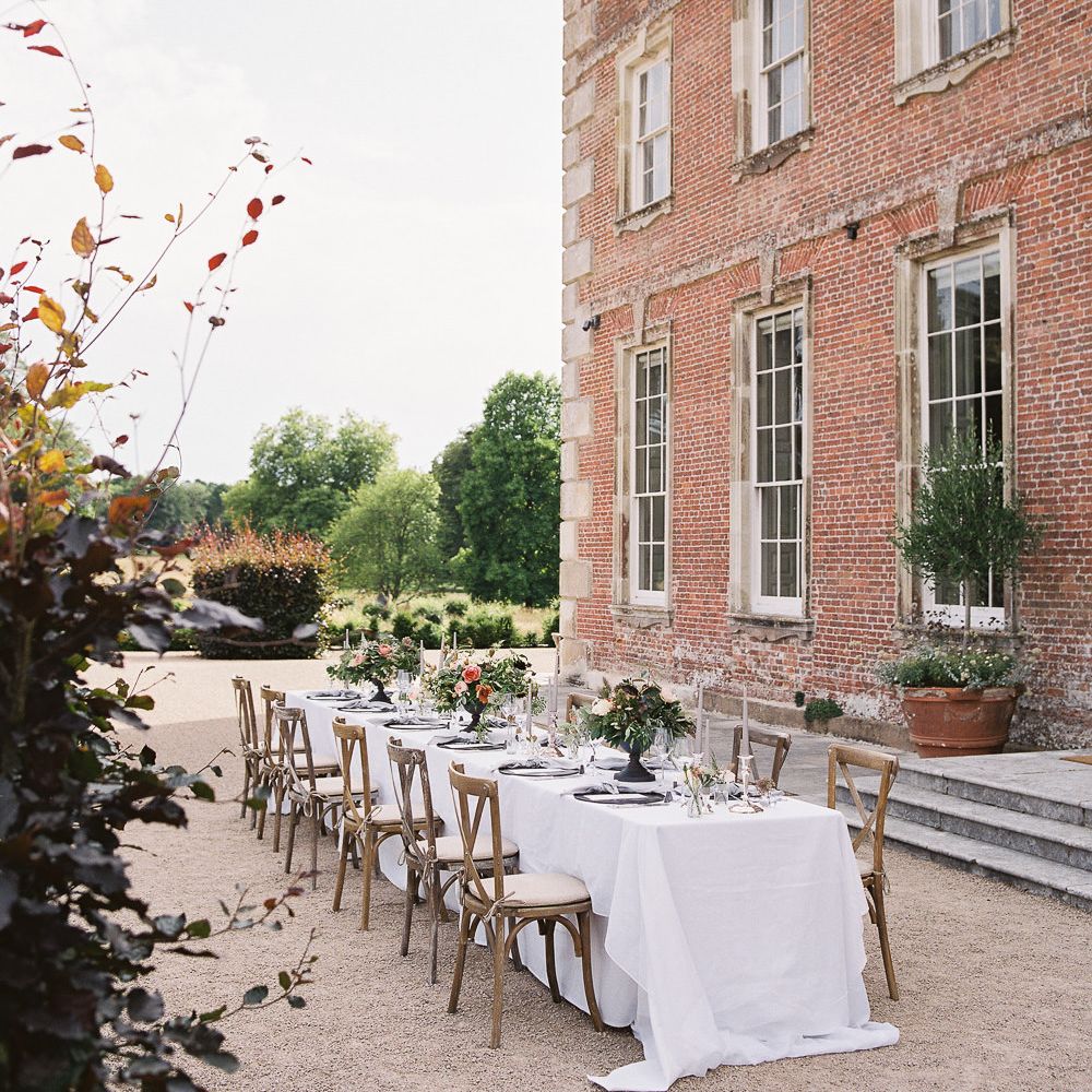 Outdoor Tablescape with Living Coral, White &amp; Greenery Floral Centrepieces | Elegant Summer Inspiration at St Giles House, Dorset by Jessica Roberts Design   Imogen Xiana Photography