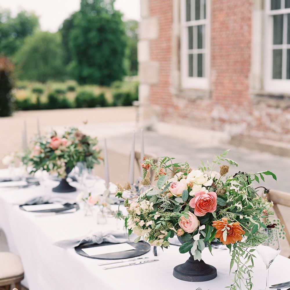 Outdoor Tablescape with Living Coral, White &amp; Greenery Floral Centrepieces | Elegant Summer Inspiration at St Giles House, Dorset by Jessica Roberts Design   Imogen Xiana Photography