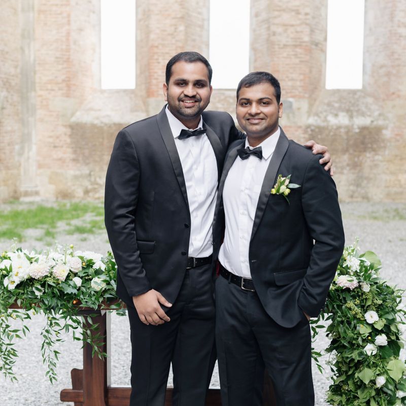 Groom and Groomsman in Black Tie Suits