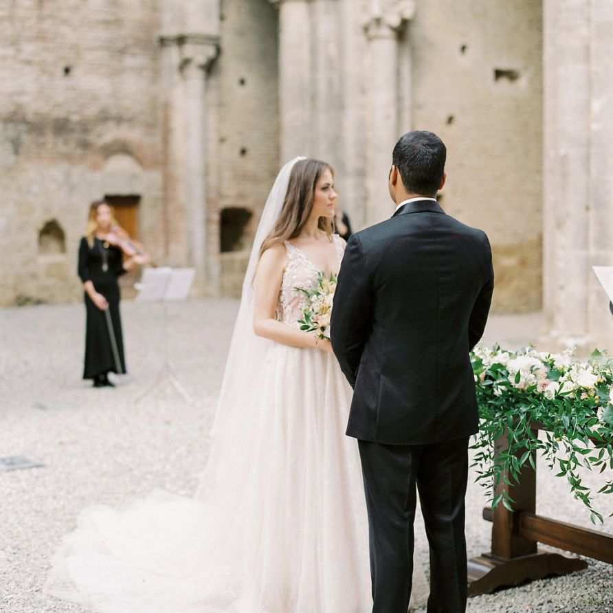 Bride and Groom Exchanging Vows at Their Open Air Church Wedding Ceremony