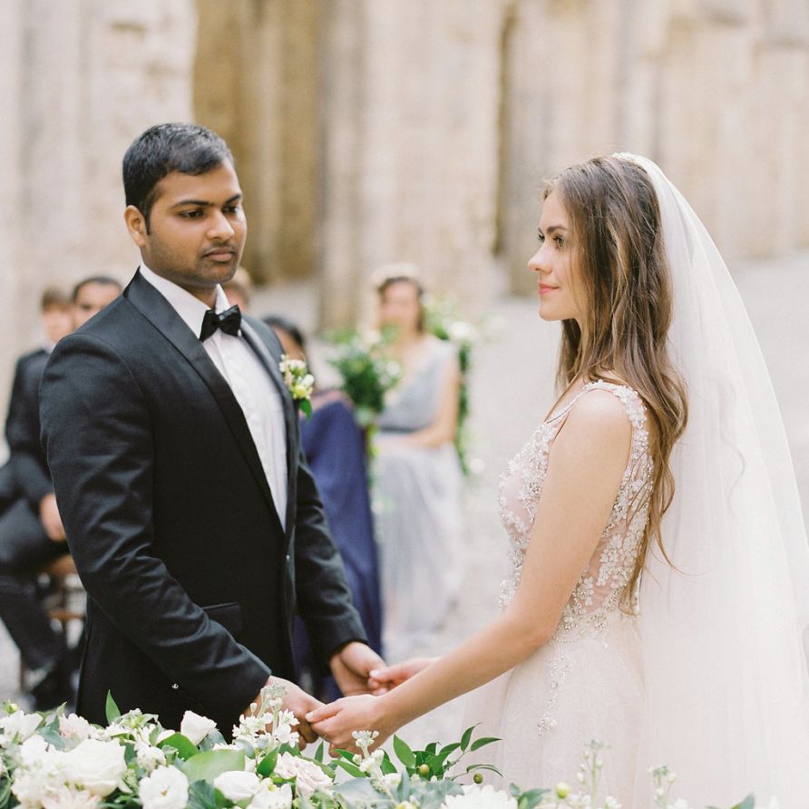 Bride and Groom Holding Hands During The Wedding Ceremony