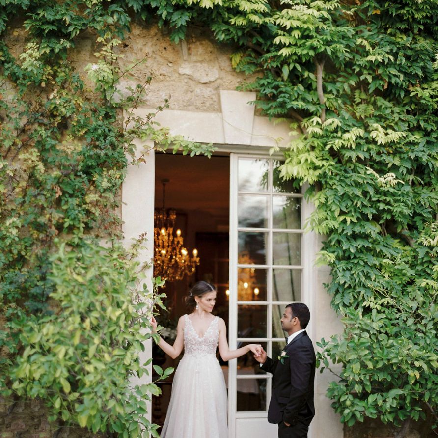Groom in Black Tuxedo Escorting his Bride in a  Rara Avis Wedding Dress