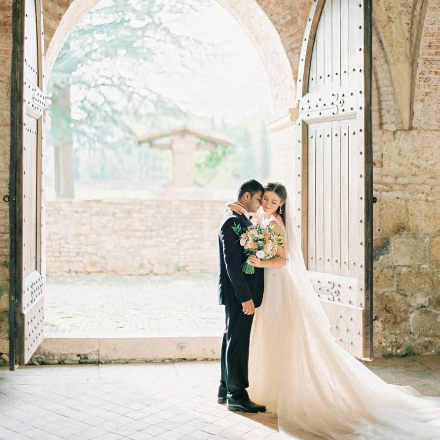 Bride in a Rara Avis Wedding Dress and Groom in Black Tie Suit Embracing