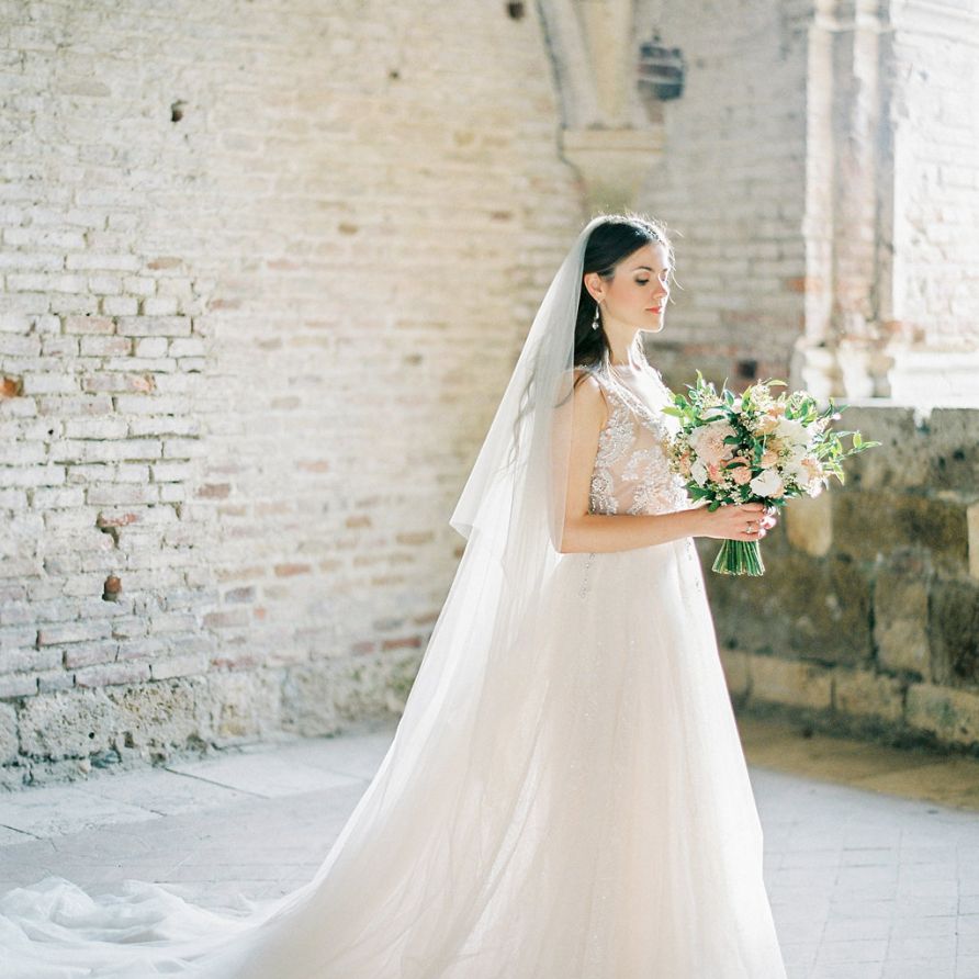 Bride in a Rara Avis Wedding Dress with Peach and White Wedding Bouquet