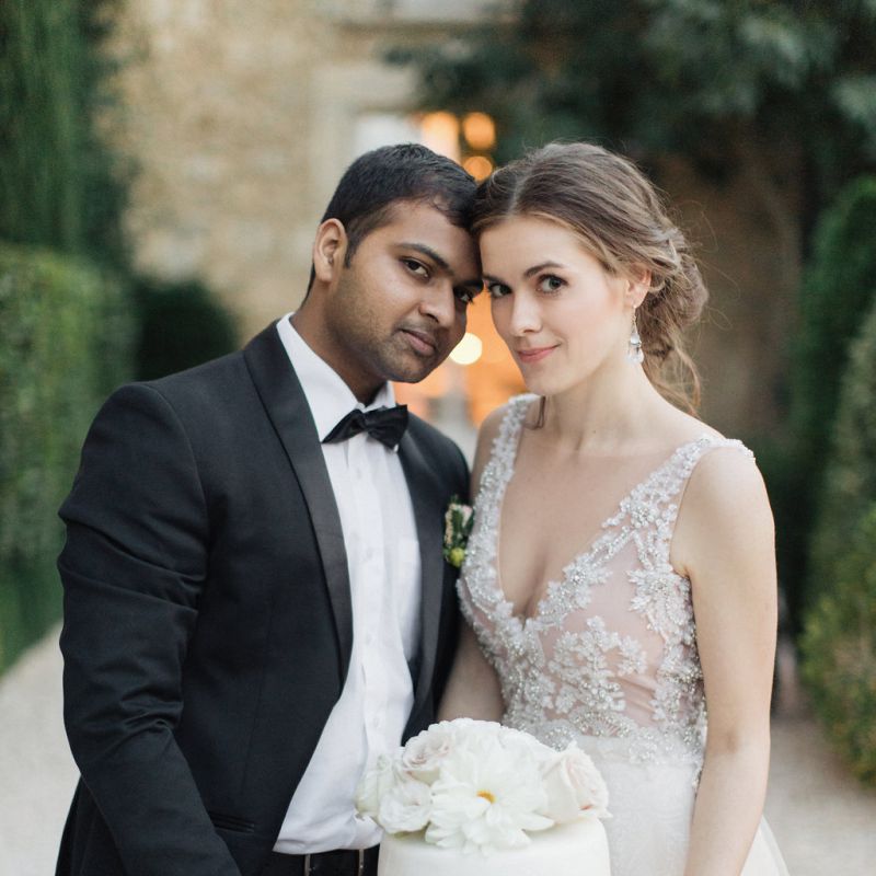 Bride and Groom with Their Elegant Wedding Cake