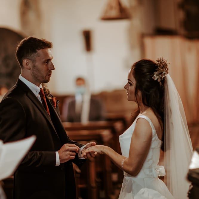 Bride and groom exchanging vows at intimate micro wedding