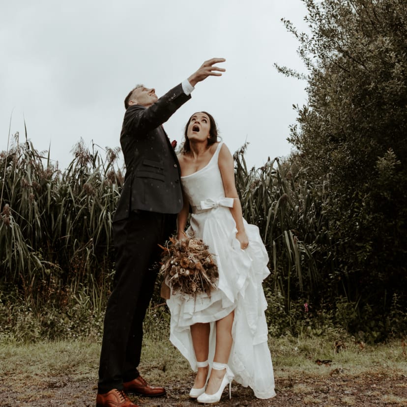 Bride and groom portrait in the rain