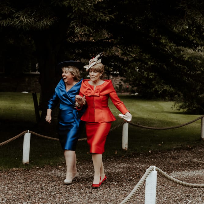 Mother of the bride and groom in red and blue dresses