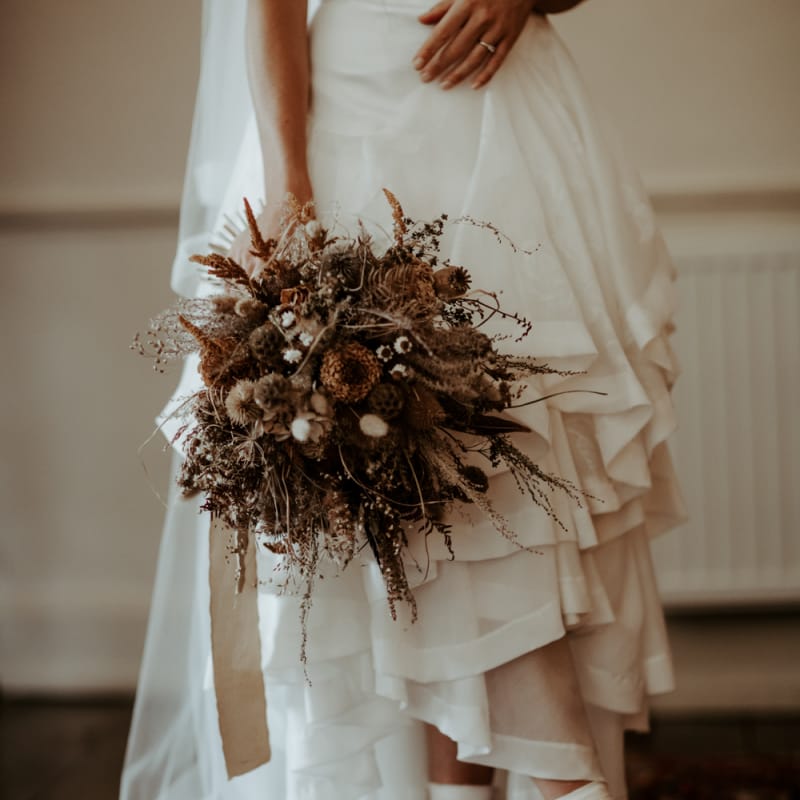 Dried flower wedding bouquet and high and low wedding dress
