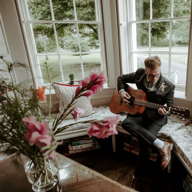 Wedding guest playing guitar