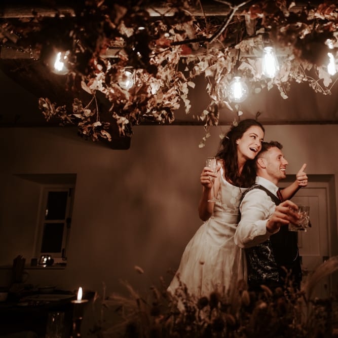 Bride and groom embracing at September 2020  wedding reception f