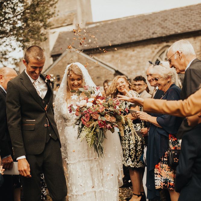 Confetti exit for groom and bride in Eliza Jane Howell wedding dress