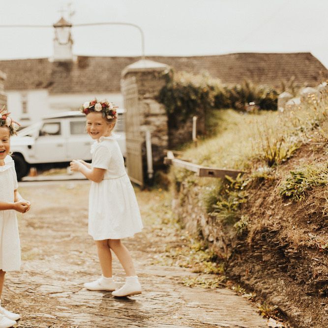 Flower girls in flower crowns and white dresses
