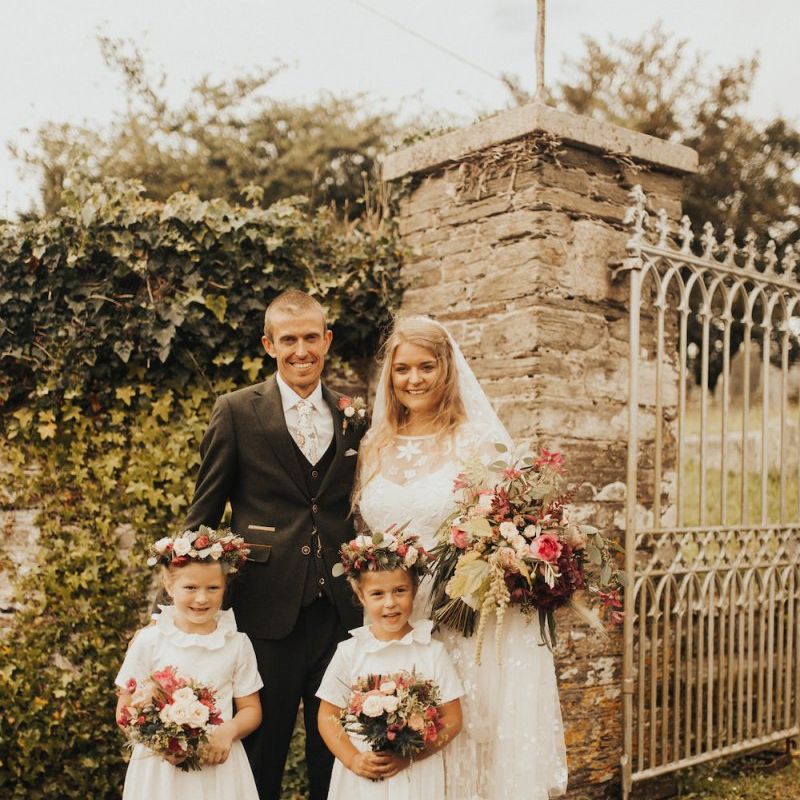 Bride in Eliza Jane Howell wedding dress with groom and flower girl daughters