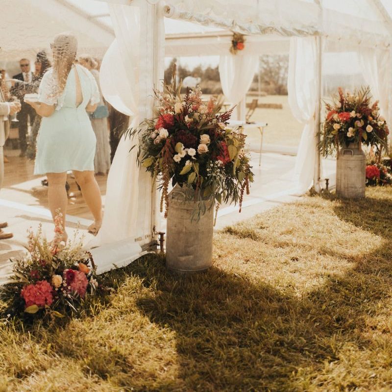 Wedding flowers at marquee entrance