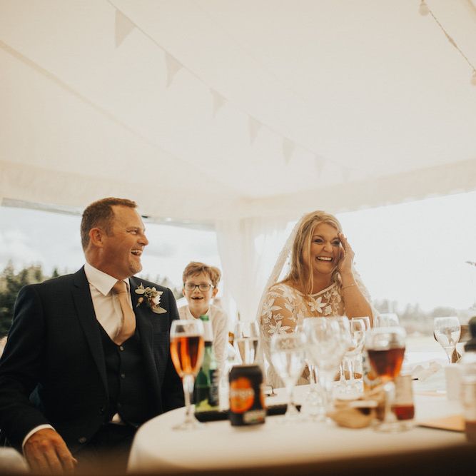 Bride in Eliza Jane Howell wedding dress enjoying the wedding speeches