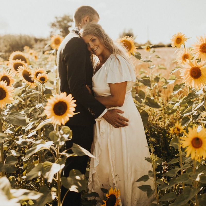 Bride and groom in sunflower field