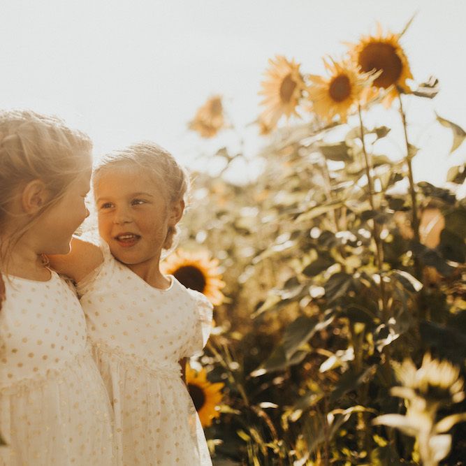 Flower girl portrait in sunflower field