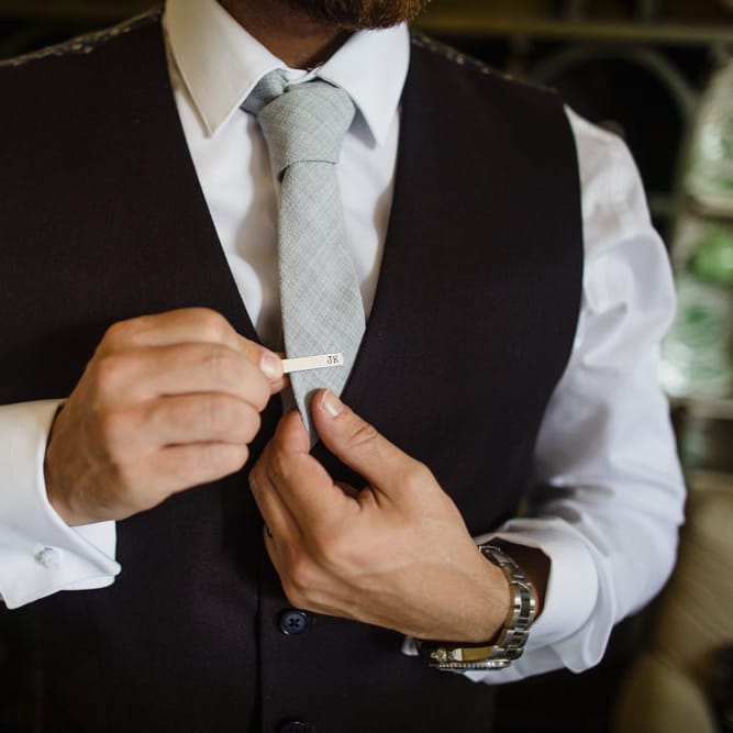 Groom in Black Three Piece Suit with Grey Tie and Personalised Tie Clip | Ivania Pronovias Wedding Dress with Long Sleeves and Minimalist Styling | Chris Barber Photography