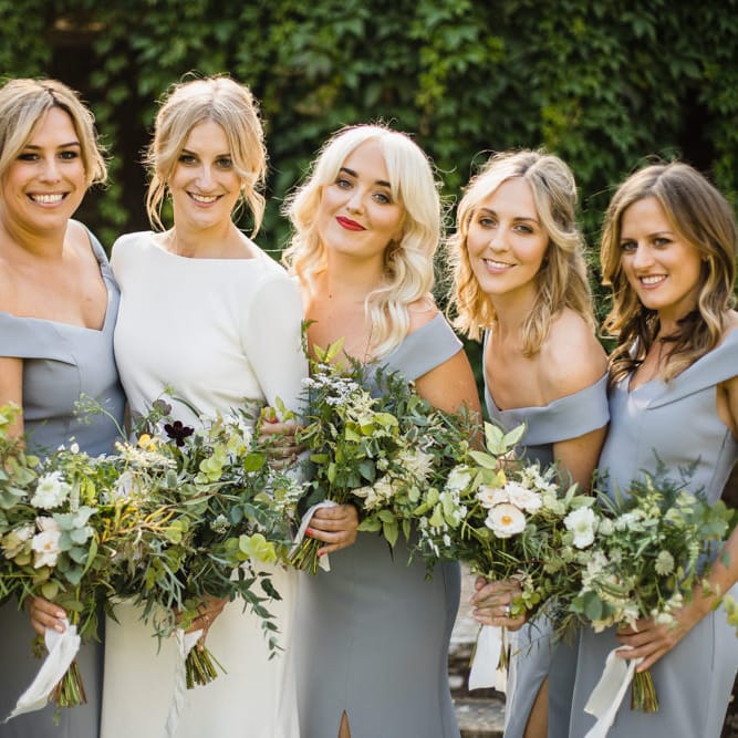 Bride in Long Sleeved Wedding Dress with Plunging V Back and Cuff Buttons by Pronovias | Bridal Up Do | Bridesmaids in Grey Off Shoulder Dessy Dresses with Side Split | Bouquets of Scabious, Ammi Majus, Veronica, Snowberries, Chocolate Cosmos, Black Scabious, Cafe au Lait Dahlias and Majolica Spray Roses with White Trailing Ribbon | Ivania Pronovias Wedding Dress with Long Sleeves and Minimalist Styling | Chris Barber Photography